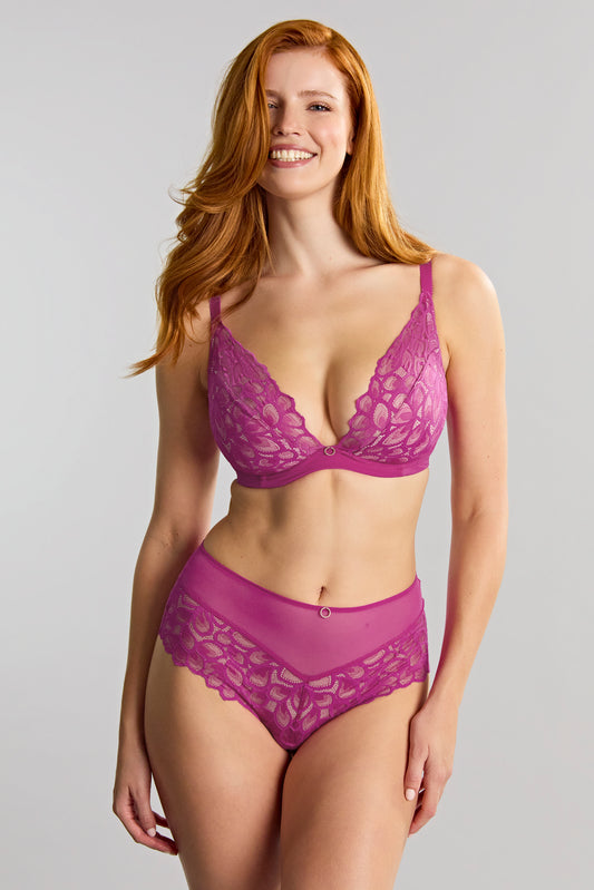 Woman wearing a purple lace lingerie set on a plain background