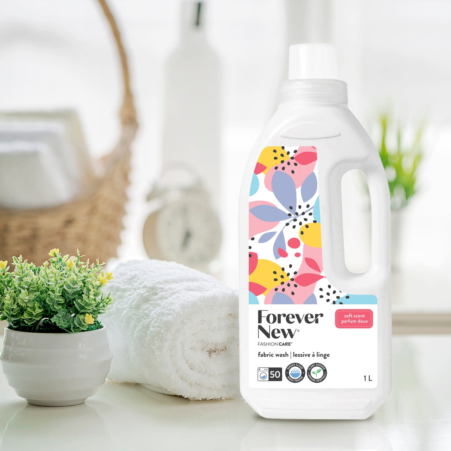 Forever New Liquid Large Fabric Wash Soft Scent on top of counter next to clean towel