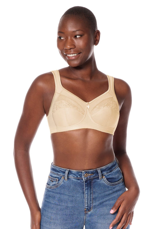 Woman wearing Isadora wireless beige bra and blue jeans on a white background