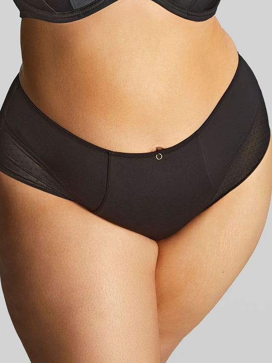 Black underwear worn by a person on a gray background