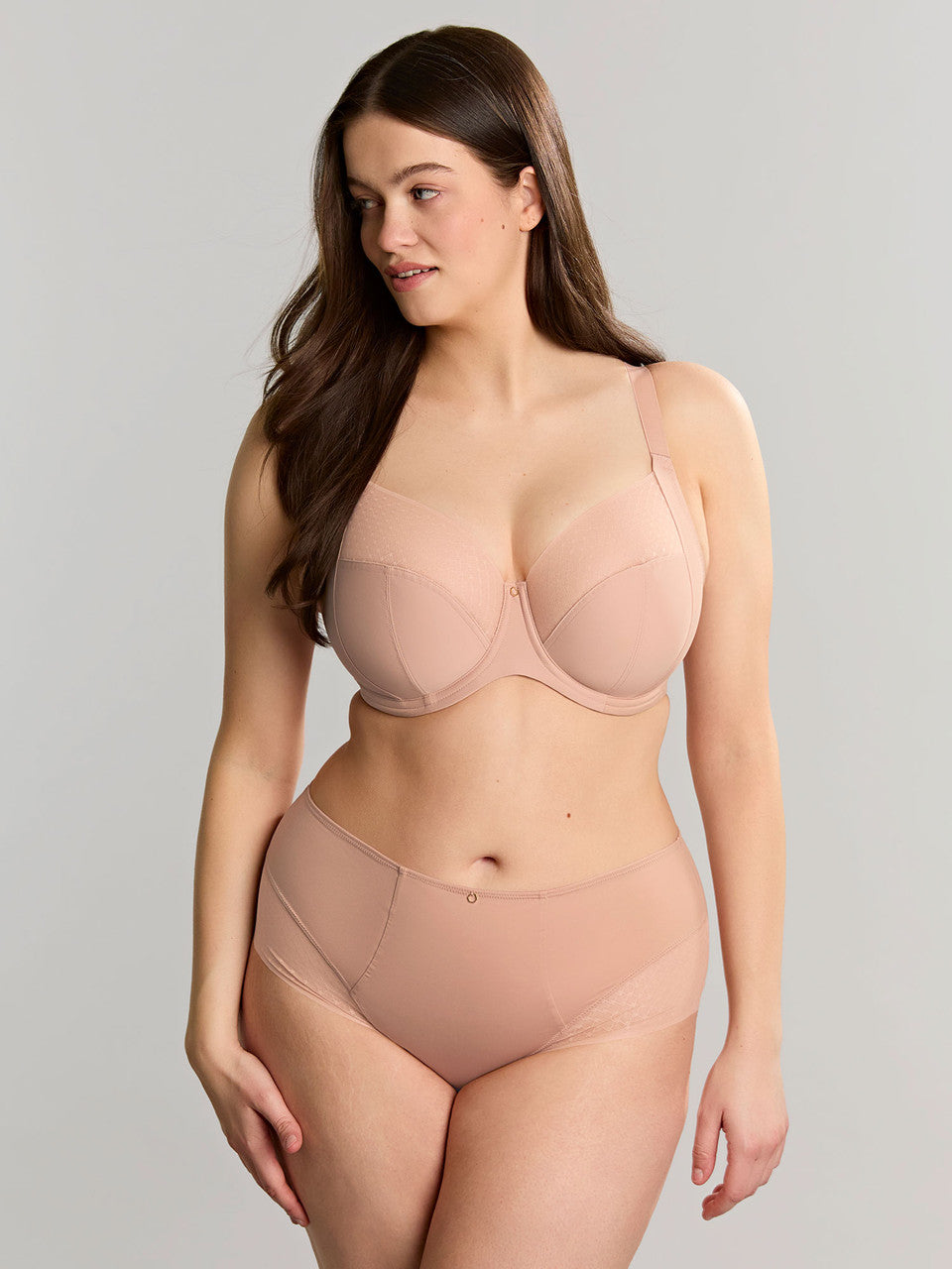 Model wearing a beige Bliss bra and matching deep brief, front three-quarter view
