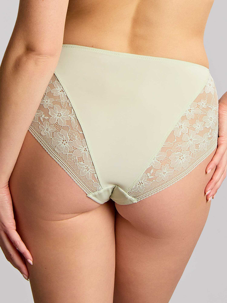 Beige lace-trimmed underwear on a neutral background