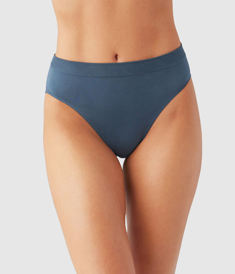 Blue underwear worn by a person on a white background
