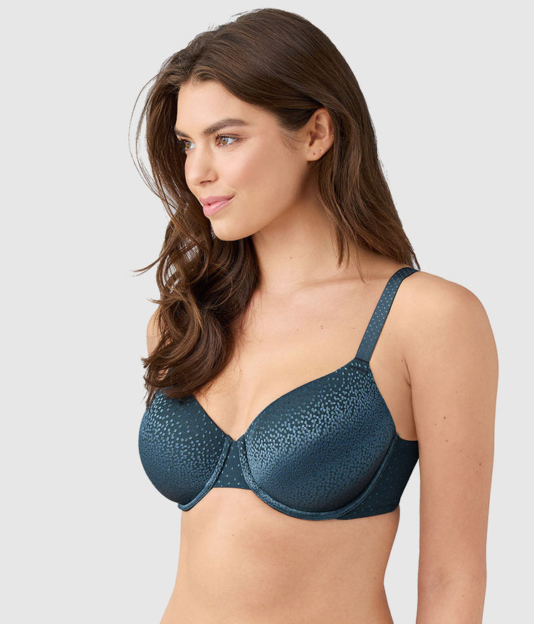 Woman wearing a blue bra against a light gray background