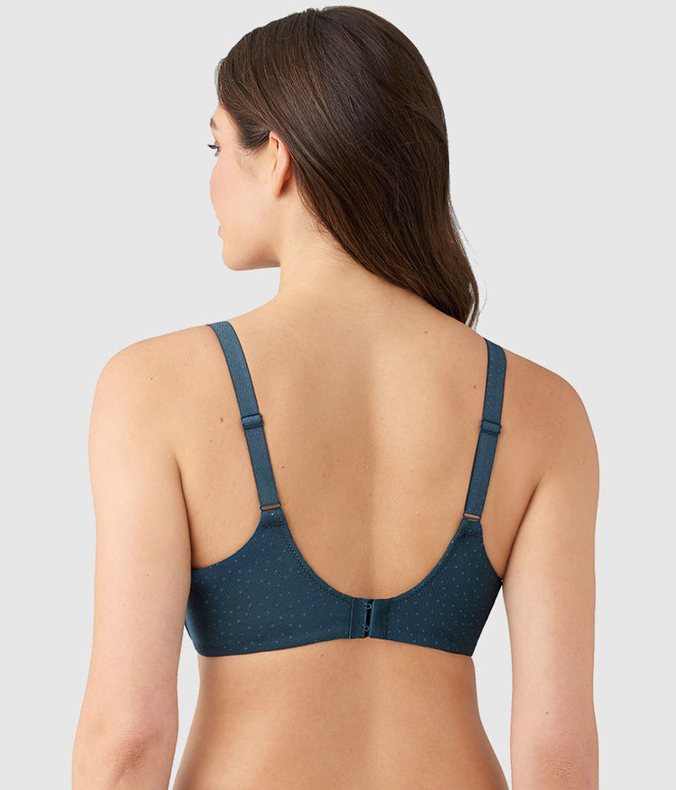 Woman wearing a blue bra on a gray background