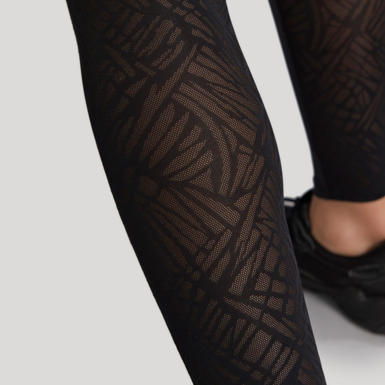 Ultra Adapt Sports Legging - Black worn by model close up of sheer leg panel view