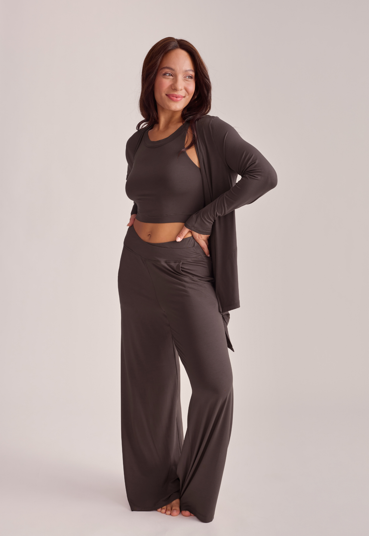 A woman modeling a dark brown two-piece lounge set.