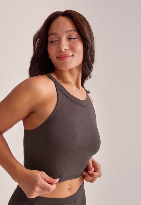 A woman wearing a brown tank top and matching bottoms, front view.