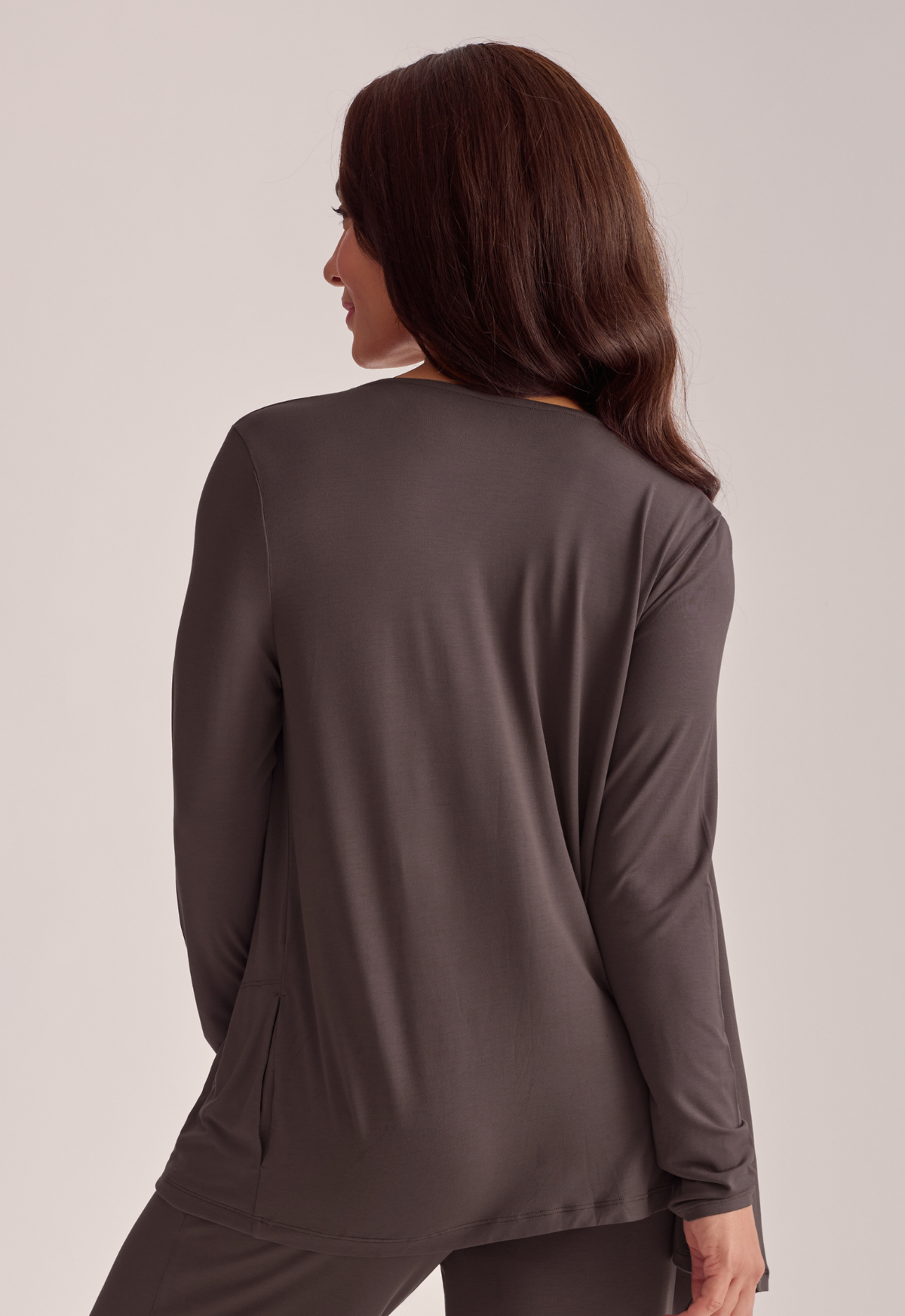 A woman shown from the back wearing a dark brown long-sleeve top and matching pants.