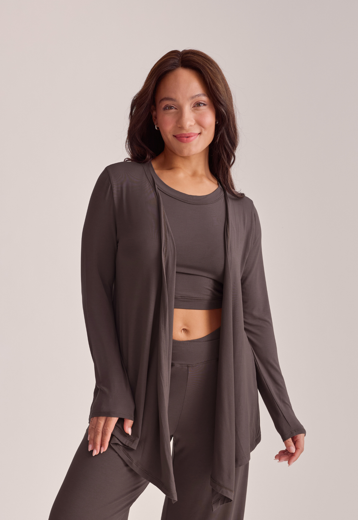 A woman modeling a matching dark brown loungewear set.