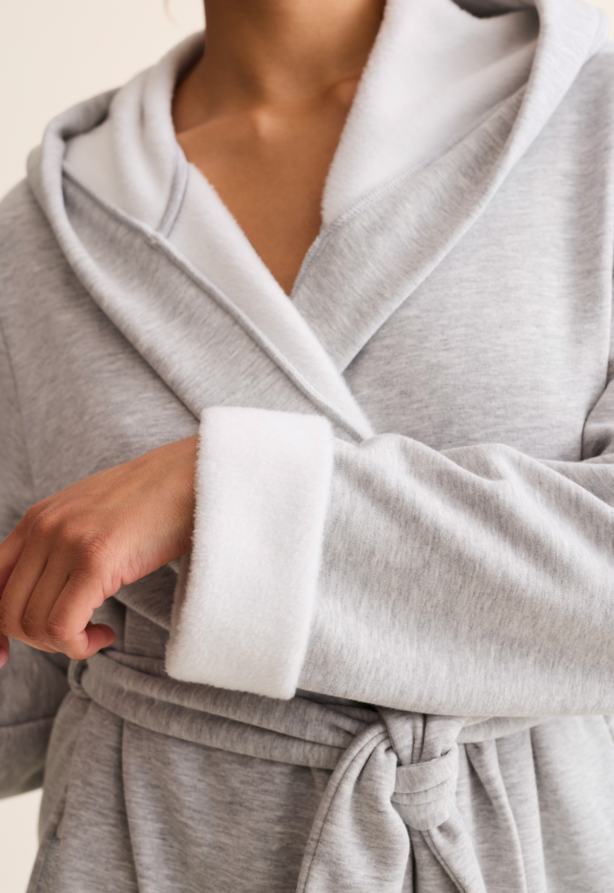 Gray robe with white trim worn by a model