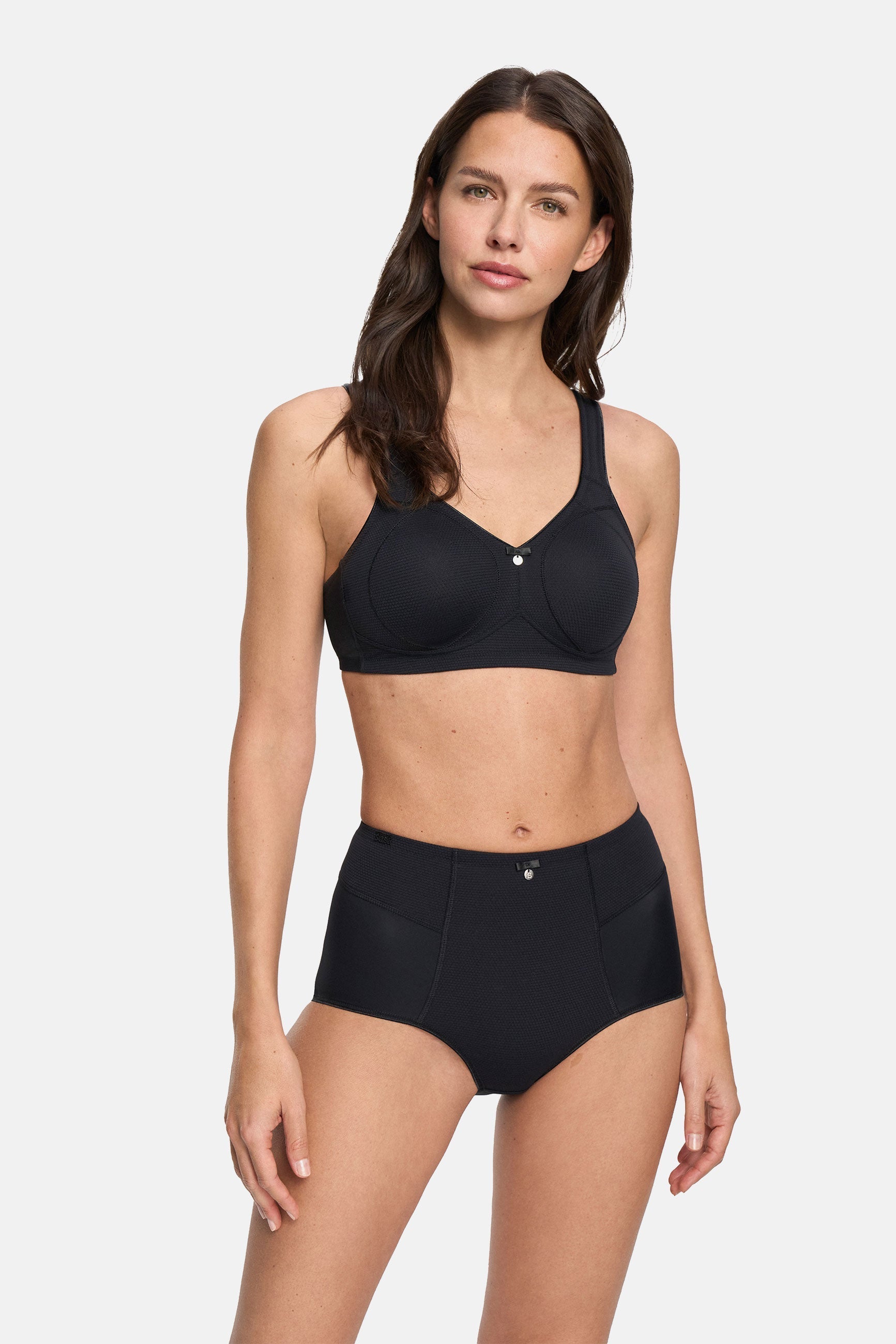Woman wearing a black bra set on a white background