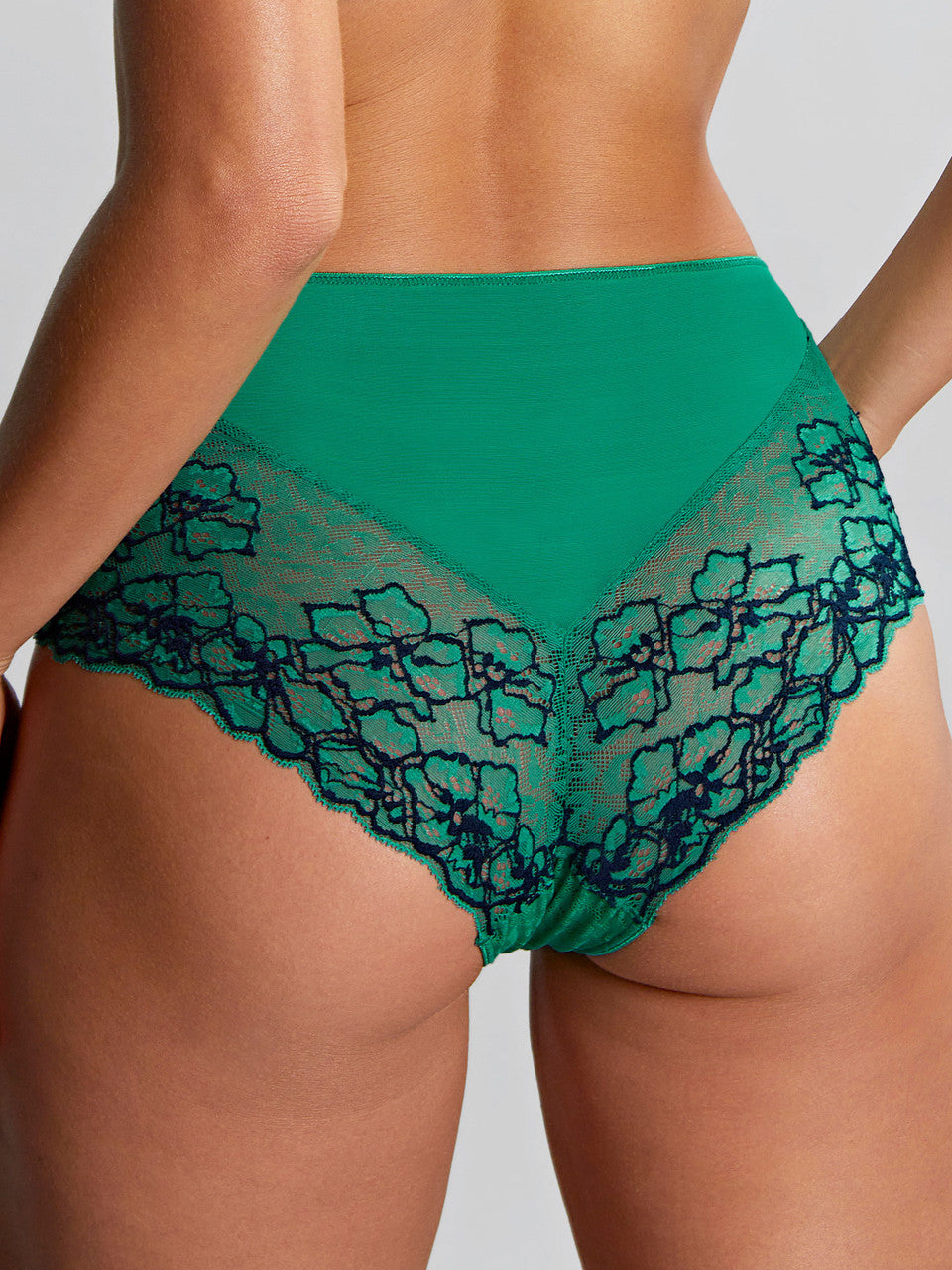 Model wears Envy Deep Brief in Emerald Leopard from behind.