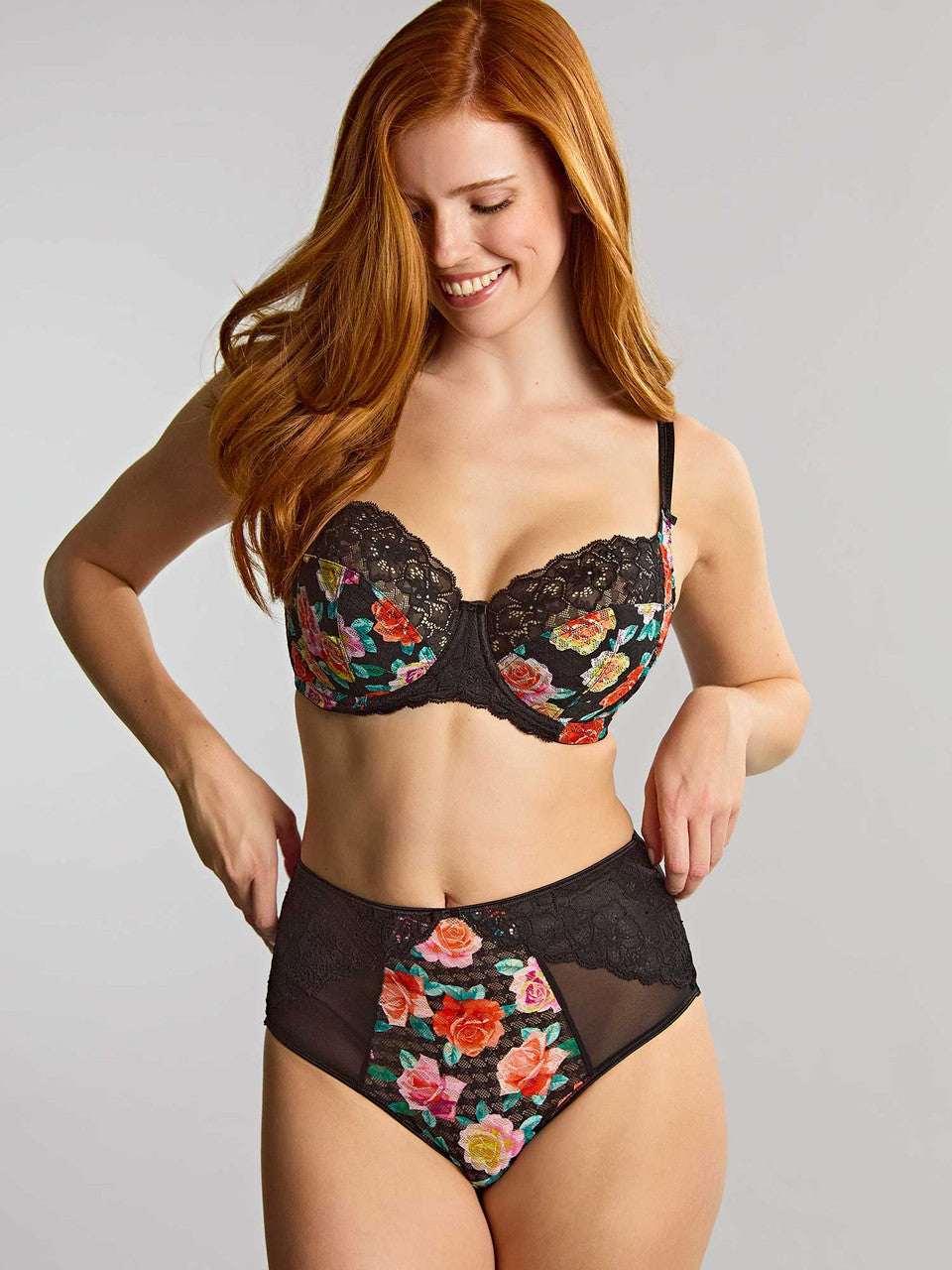 Model wears a lingerie set featuring a black lace trim and a vibrant multicolor floral print.