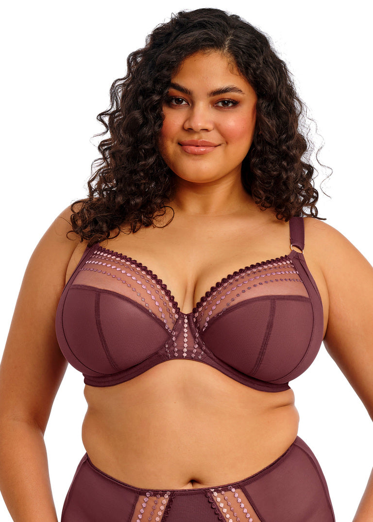 Woman wearing a maroon bra and underwear set on a white background
