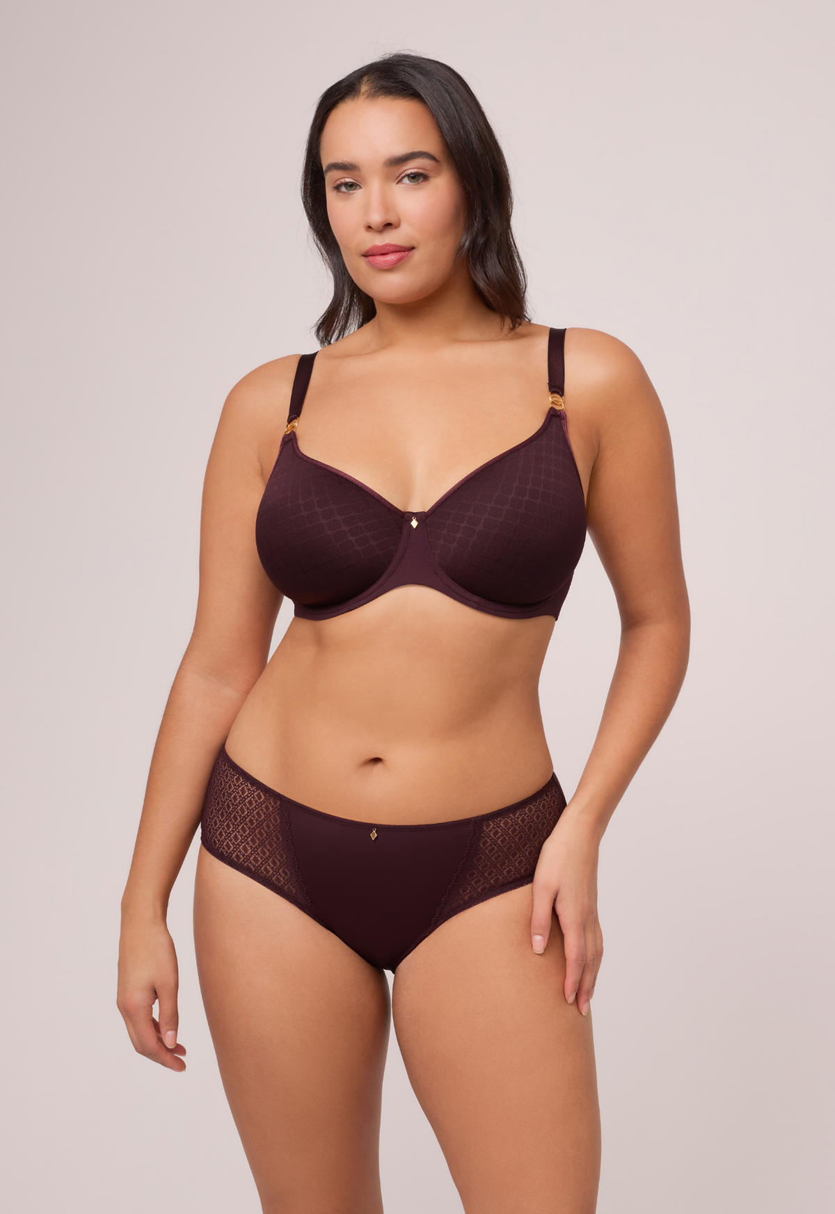 A woman modeling a textured underwire bra and matching briefs, front view