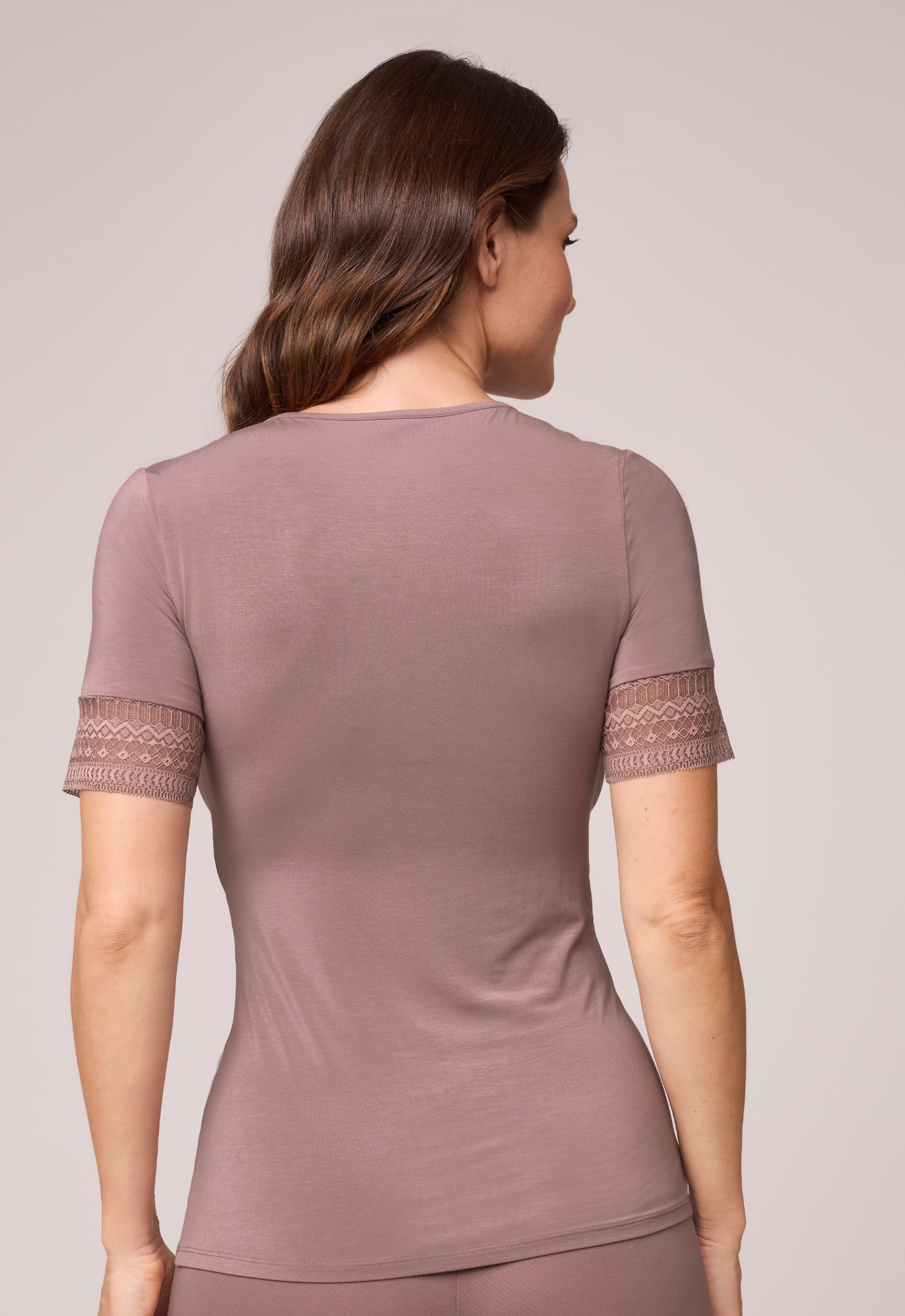 Woman wearing a plain round neck t-shirt in cappuccino with short lace sleeves