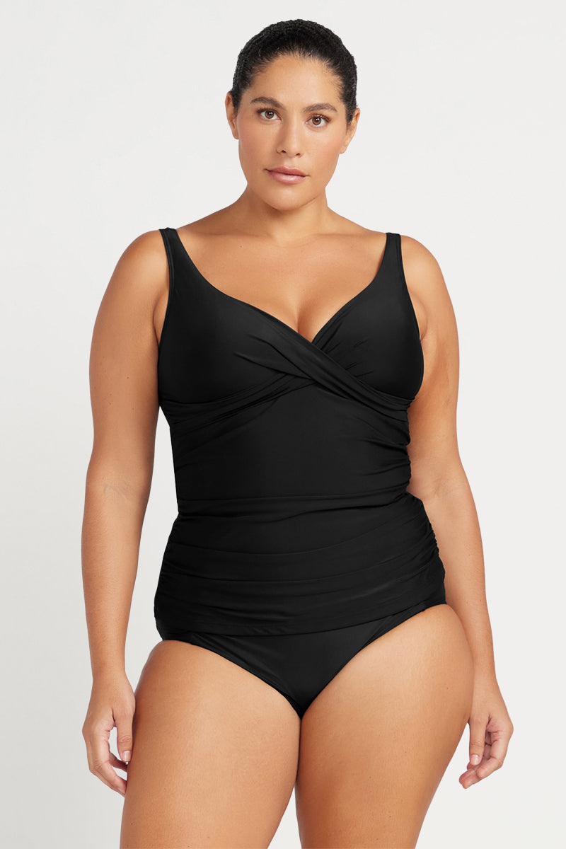 Woman wearing a black swimsuit on a white background
