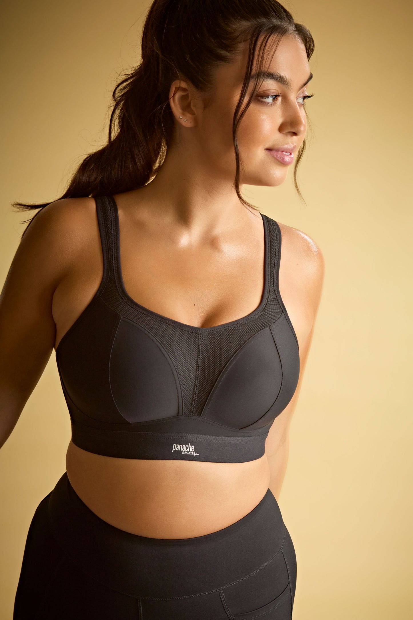 Woman wearing a black sports bra with a visible brand logo
