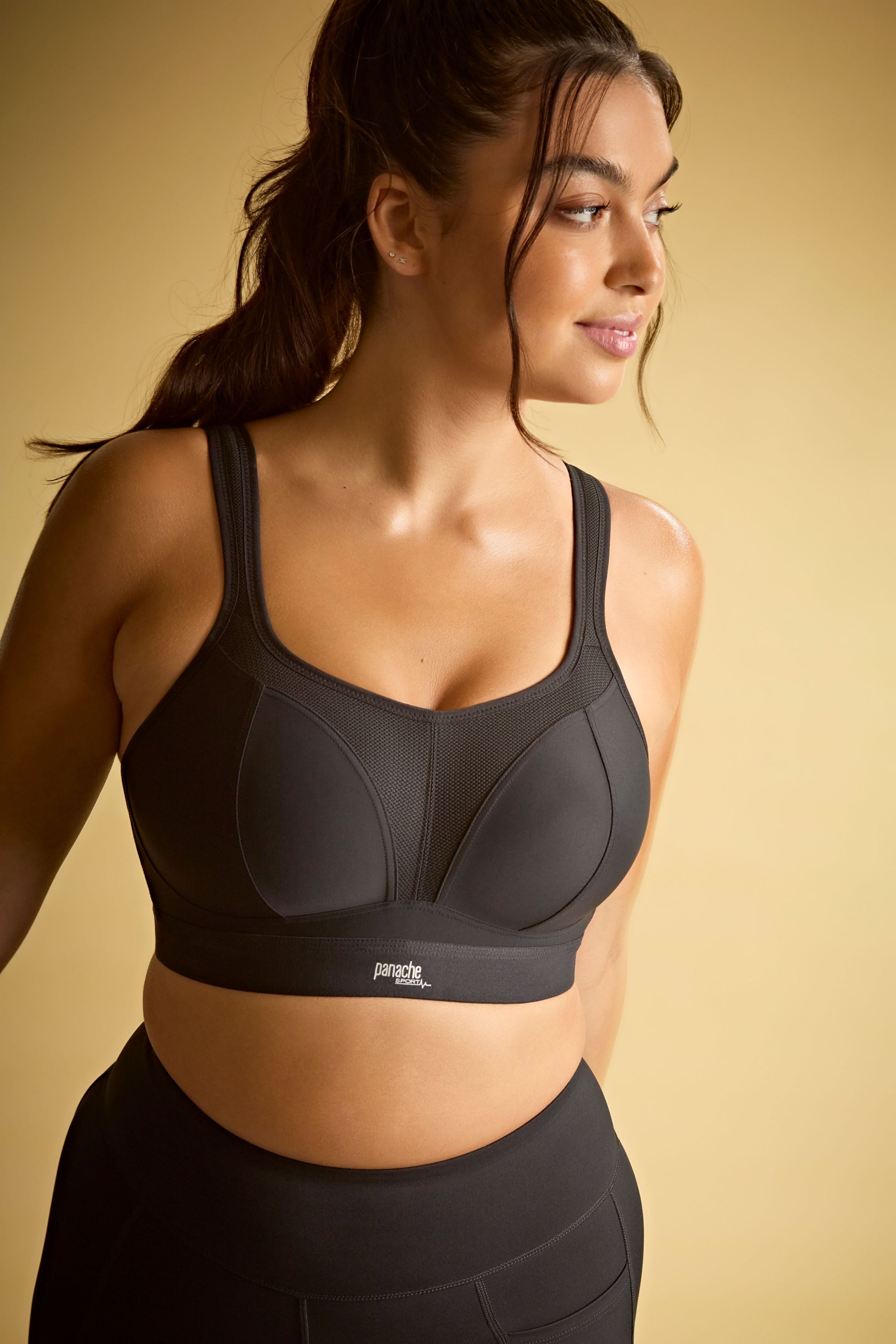 Woman wearing a black sports bra with a visible brand logo
