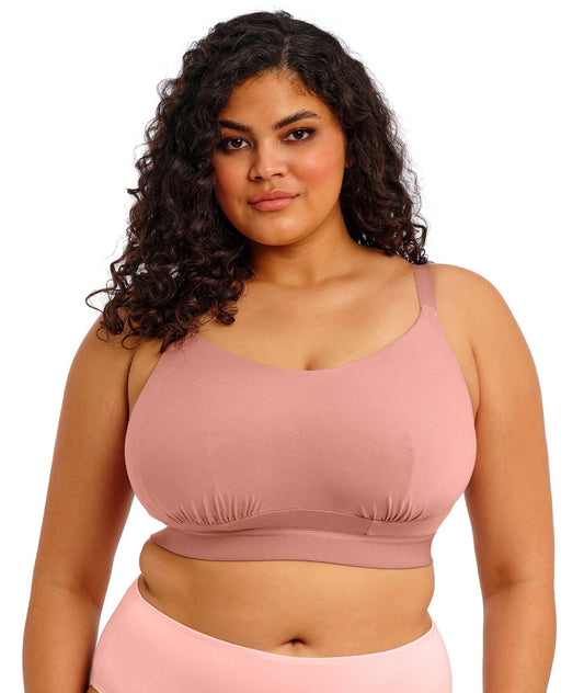 Model wearing the downtime bralette in ash rose on a white background
