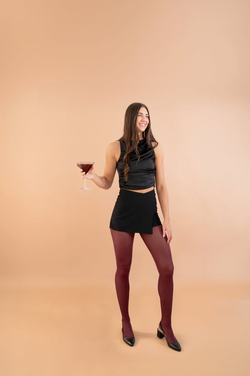 The Bordeaux Tights styled with clothes worn by model front view