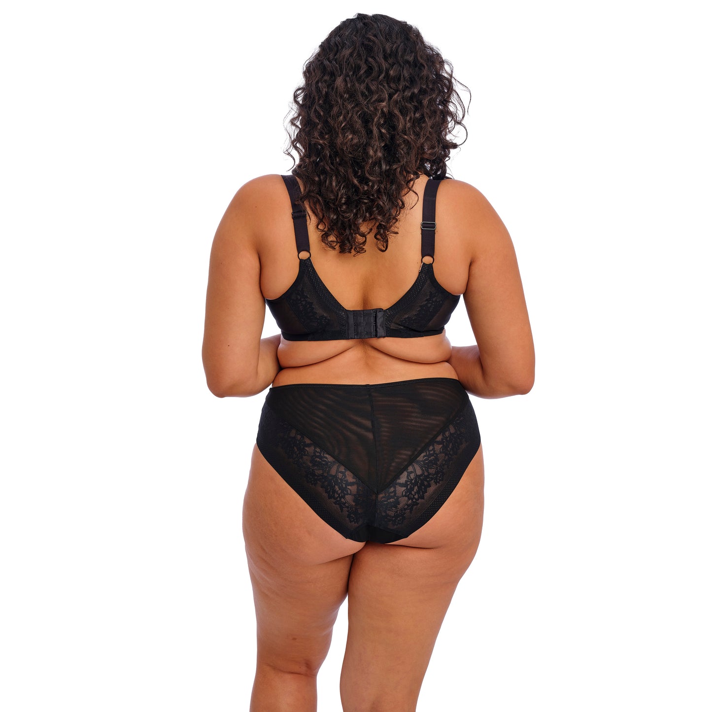 Person wearing a black lace lingerie set on a white background