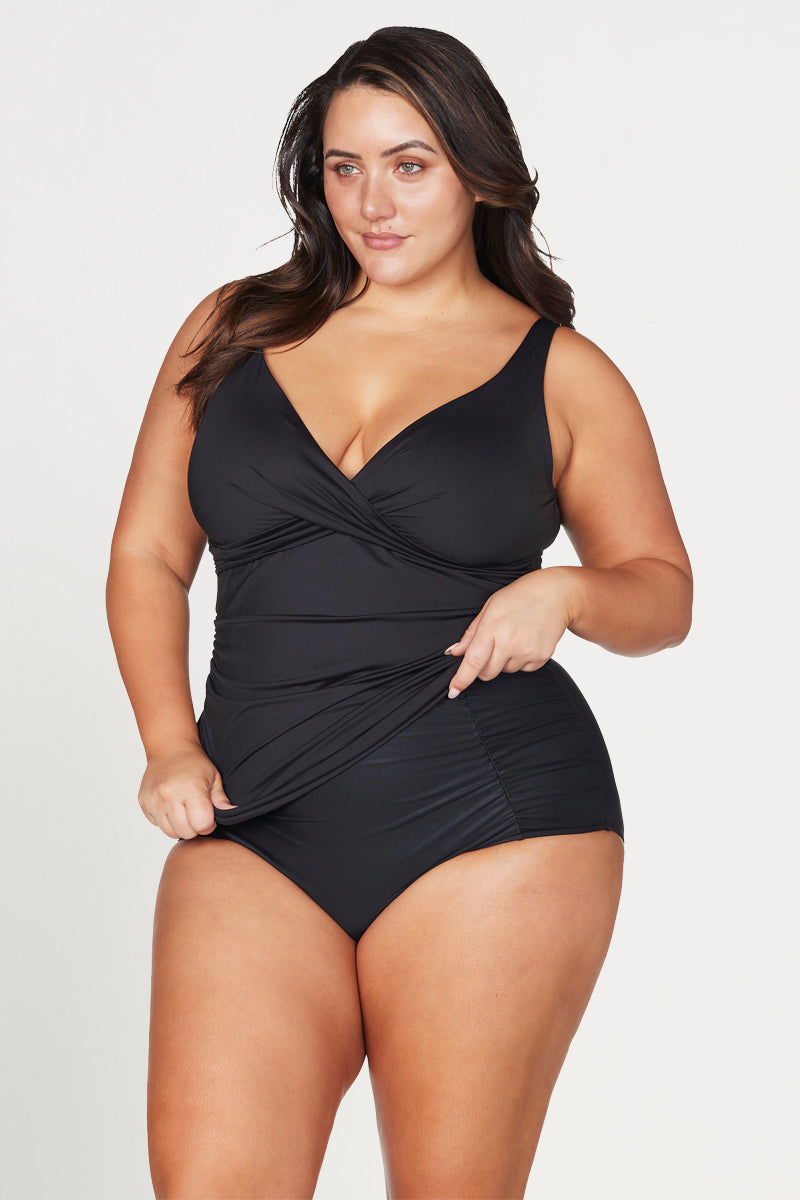 Woman wearing a black swimsuit on a white background