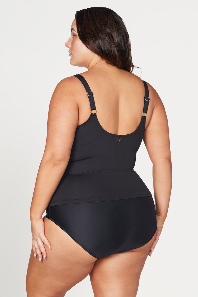 Woman wearing a black swimsuit against a white background
