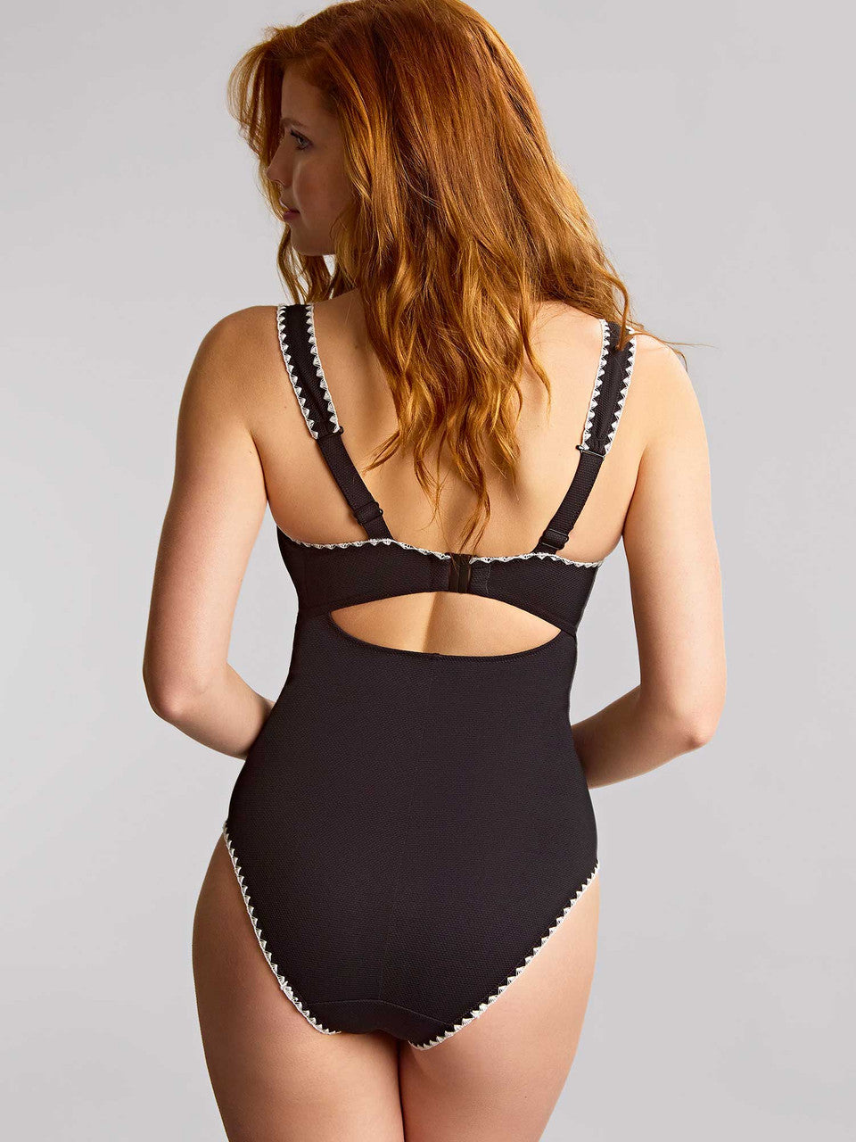 Black swimsuit with cut-out design on a gray background
