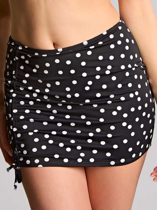 Black and white polka dot skirted brief on a plain background