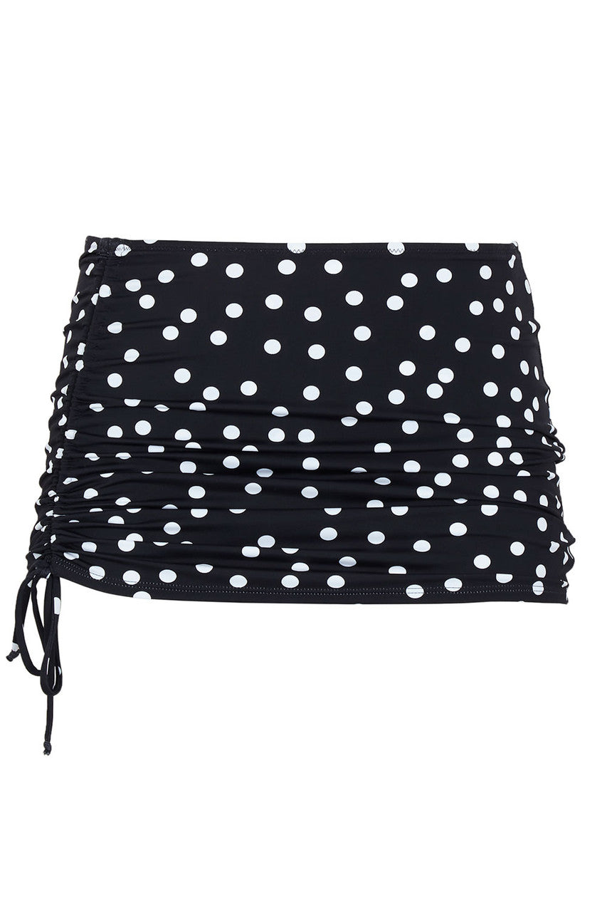 Black and white polka dotted swim skirt on a white background