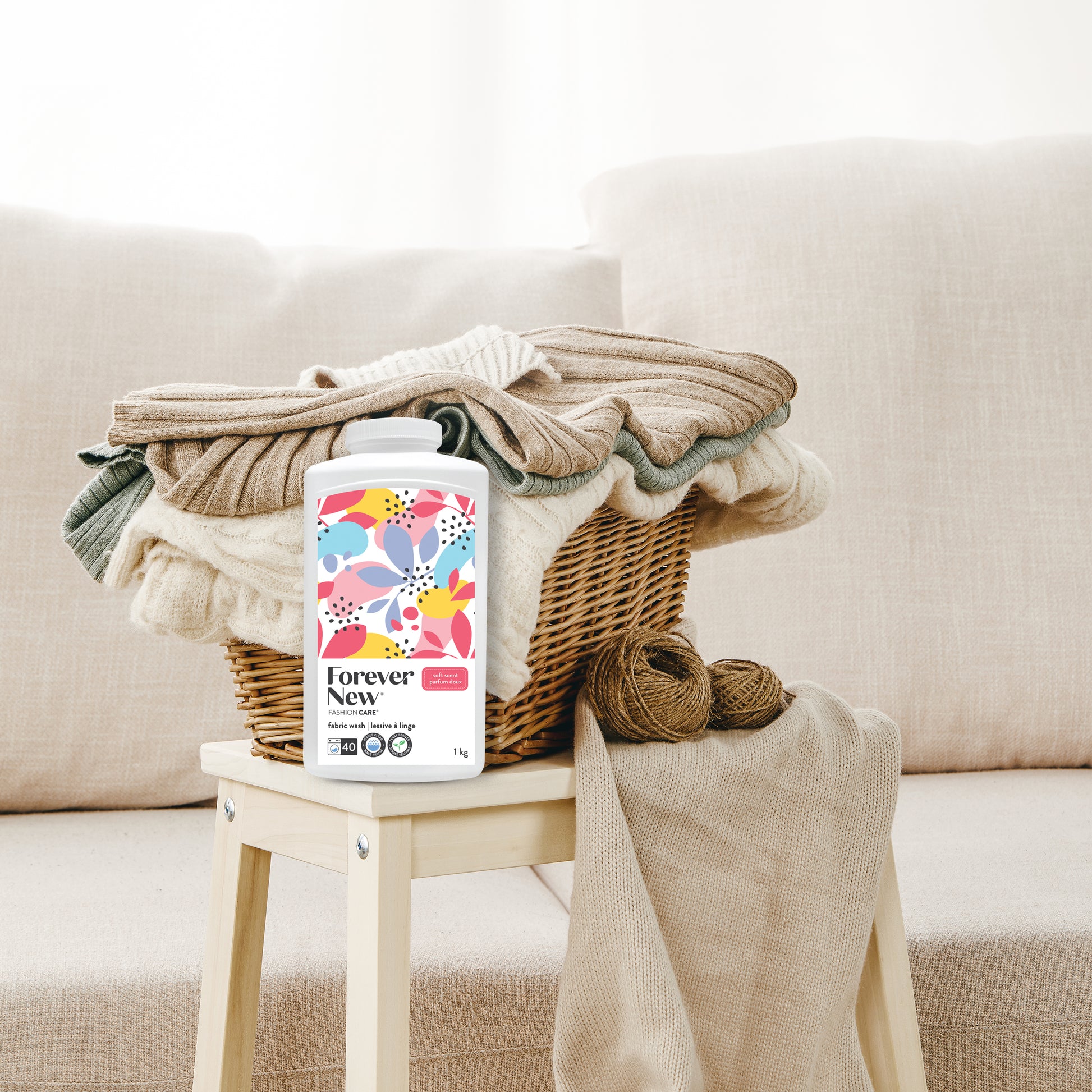 Forever New Powder Large Fabric Wash Soft Scent in front of a basket of blankets