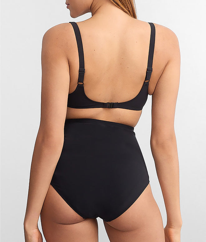 Black swimsuit worn by a model on a light gray background