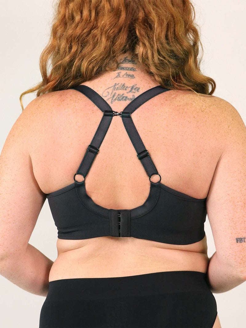 Person wearing a black sports bra with a plain background