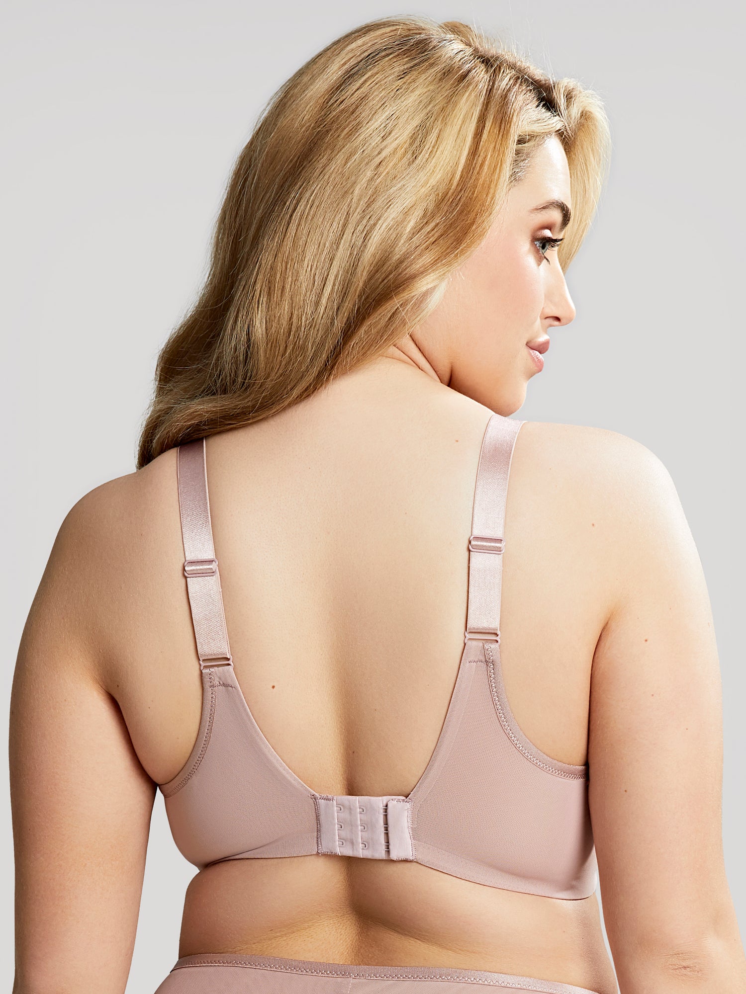Model wears Illuminate t-shirt bra in a back torso shot.