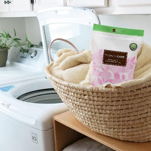 Forever New 3kg Powder Pouch Fabric Wash Soft Scented, front lifestyle view of the package in a Laundry basket.