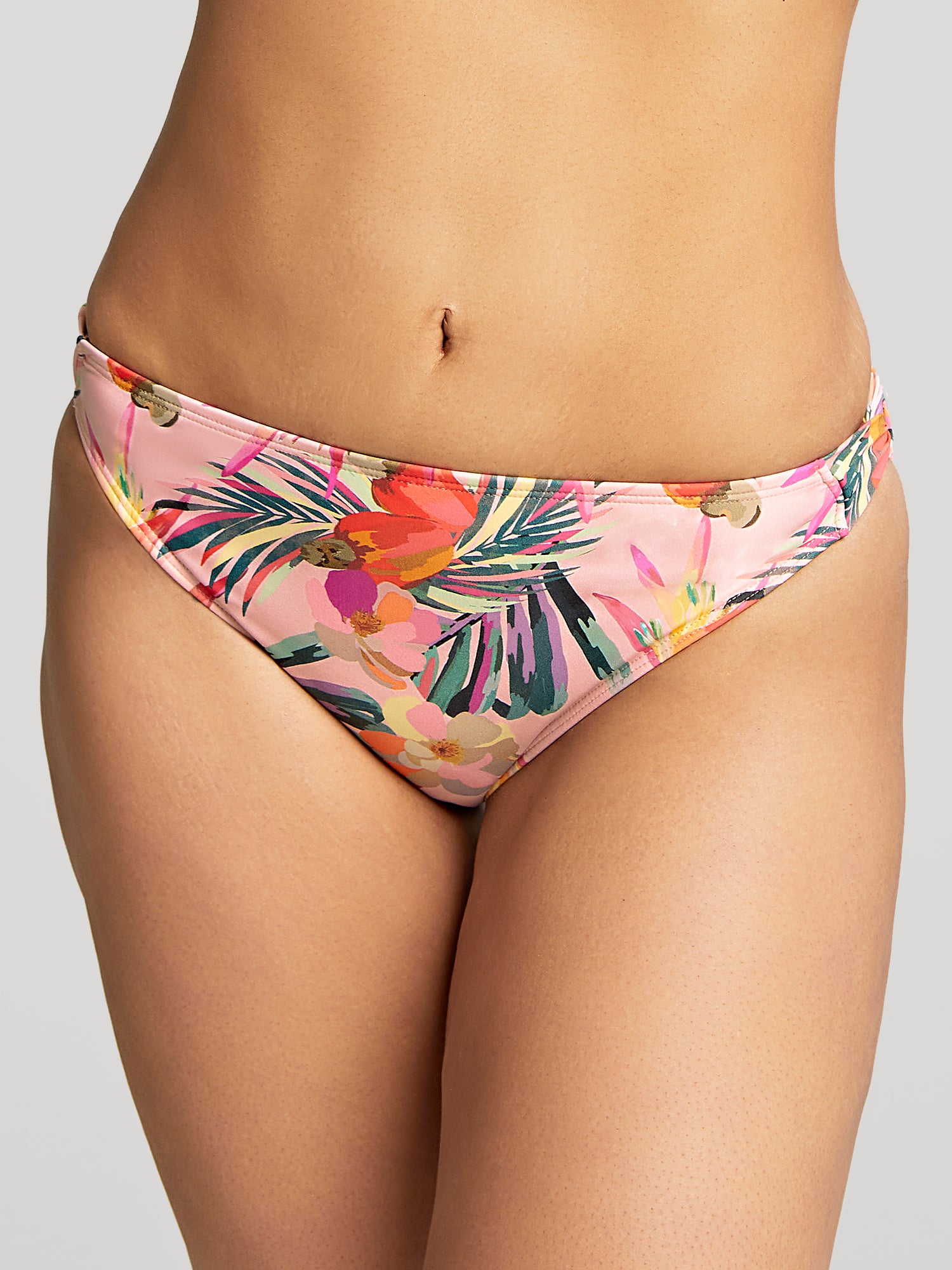 Model wears Paradise Classic Pant in Pink Tropical Print. Close up front view.