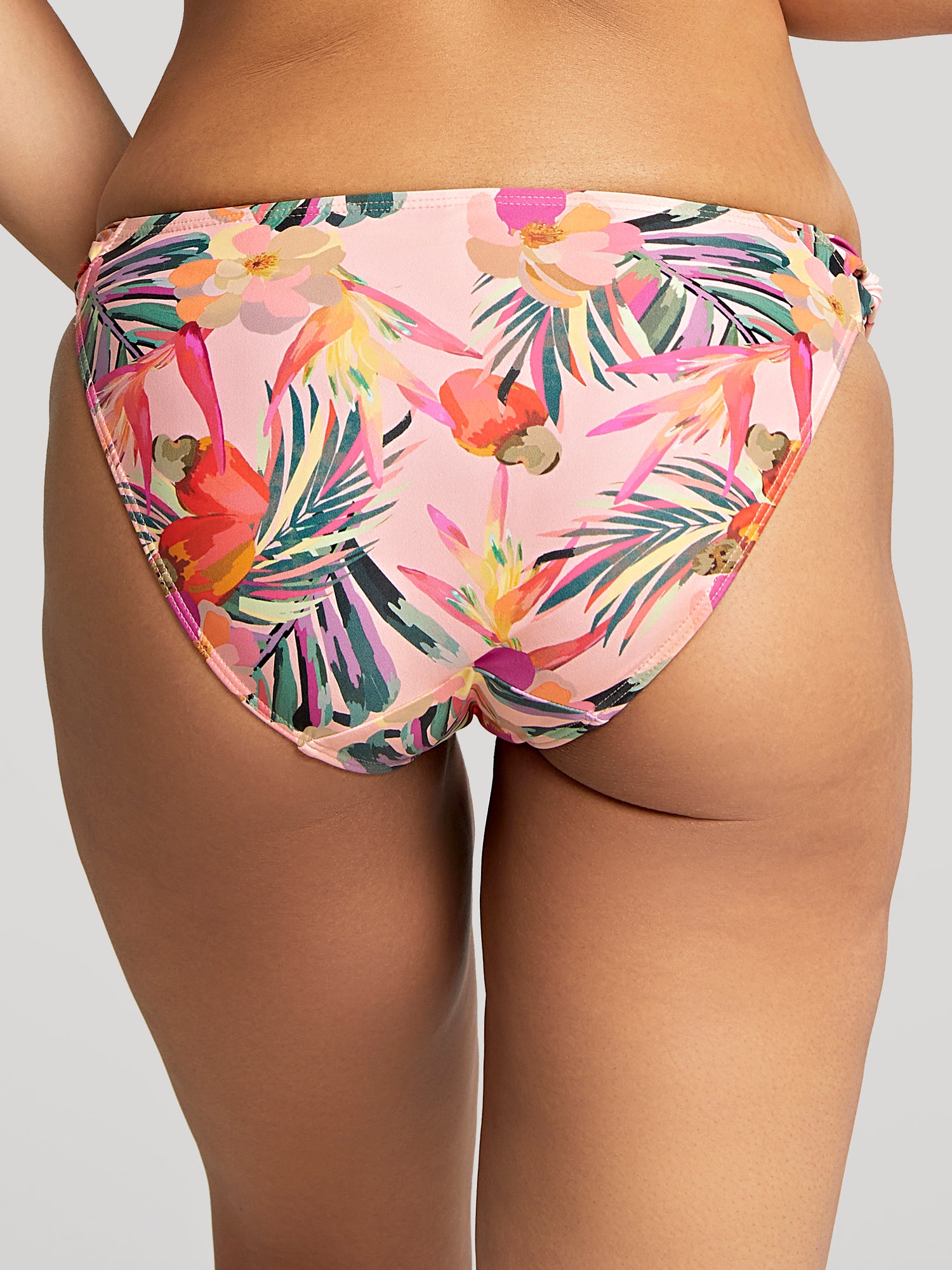 Model wears Paradise Classic Pant in Pink Tropical Print. Close up back view.